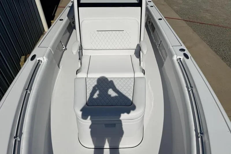 Slide: The Image of 2026 Sportsman Masters 247OE Bay Boat interior with white seating and diamond stitching. - 9
