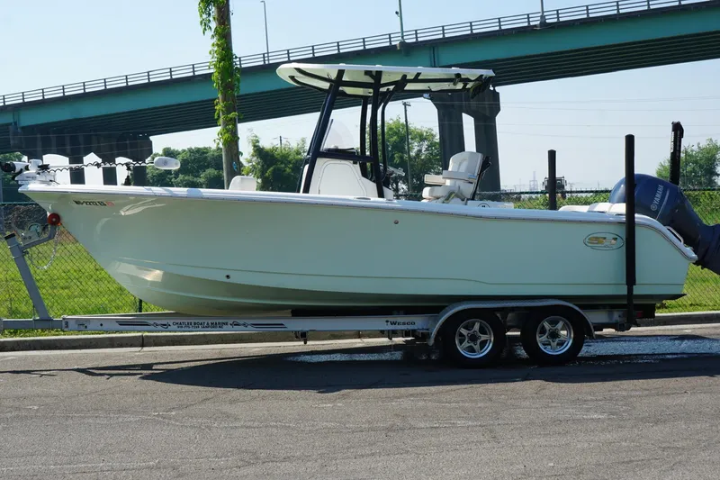 Slide: The Image of 2021 Sea Hunt Ultra 234 boat on trailer under bridge, side view. - 11