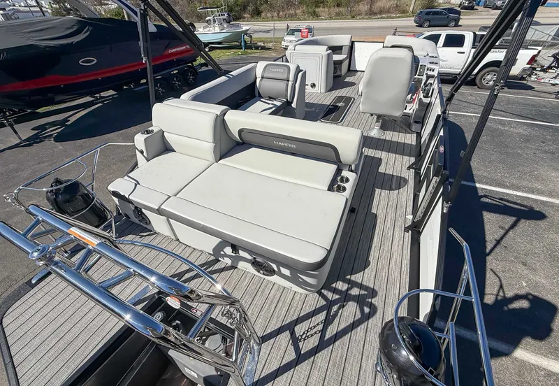 Slide: The Image of 2025 Harris Cruiser 210 SL with luxurious deck and seating area. - 10
