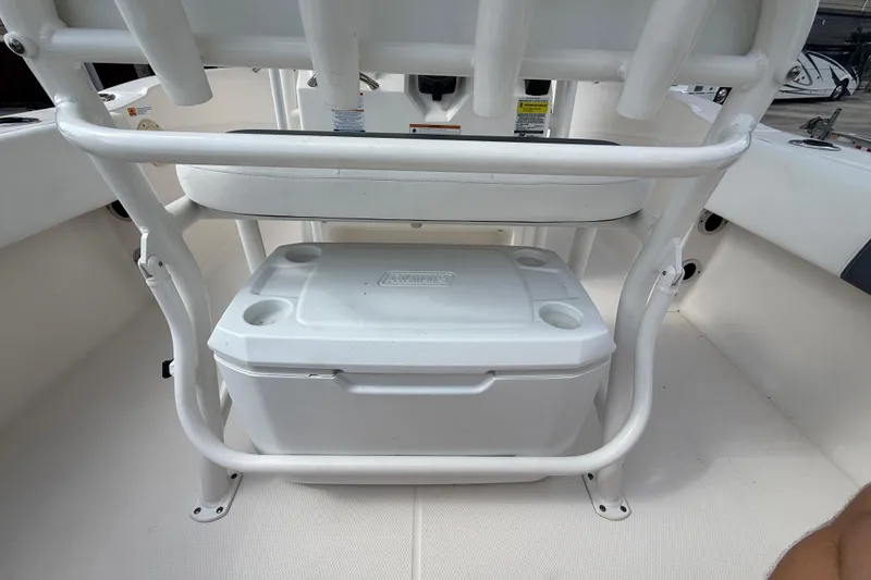 Slide: The Image of 2021 Robalo R180 Center Console boat with cooler storage under seat. - 11