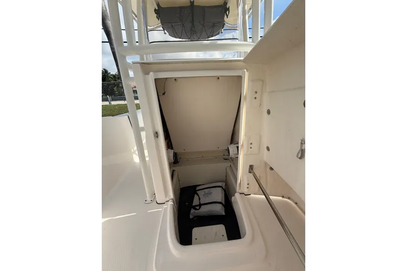 Slide: The Image of 2021 Robalo R180 Center Console storage compartment with open hatch, showcasing interior space. - 12
