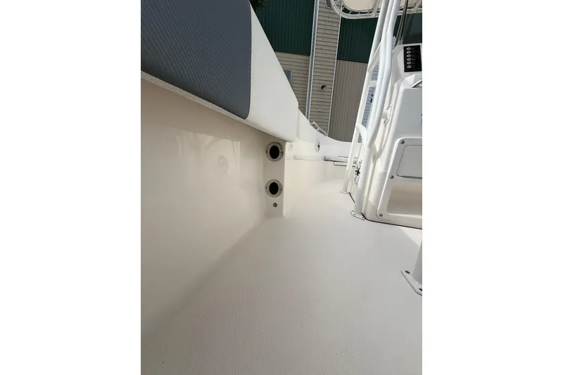 Slide: The Image of 2021 Robalo R180 Center Console boat interior, featuring sleek white deck and console. - 14