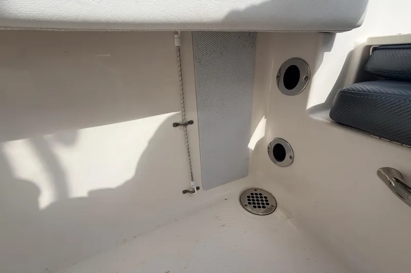 Slide: The Image of Interior view of a 2021 Robalo R180 Center Console boat, featuring drainage and seating. - 15