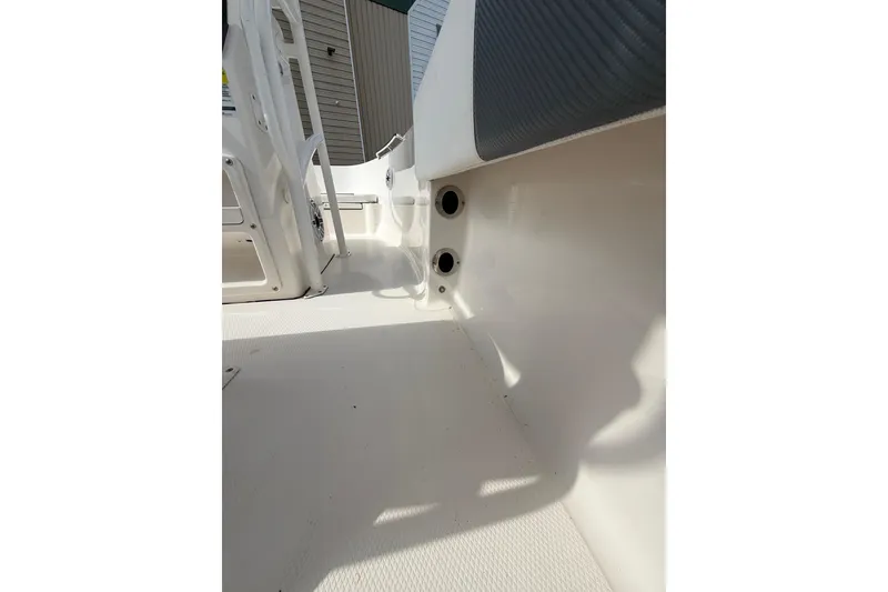 Slide: The Image of 2021 Robalo R180 Center Console interior detail, showcasing seating and deck features. - 16