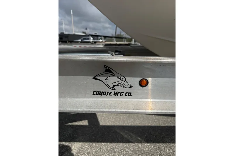 Slide: The Image of Trailer with Coyote MFG Co. logo for 2021 Robalo R180 Center Console boat. - 17