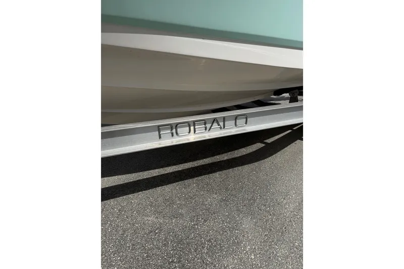 Slide: The Image of 2021 Robalo R180 Center Console boat on trailer, close-up view. - 18