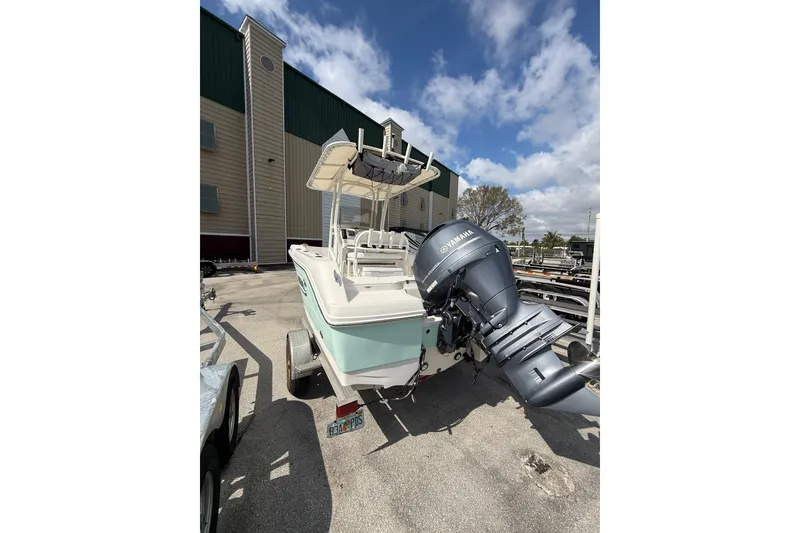 Slide: The Image of 2021 Robalo R180 Center Console boat with Yamaha outboard motor, parked outdoors. - 19
