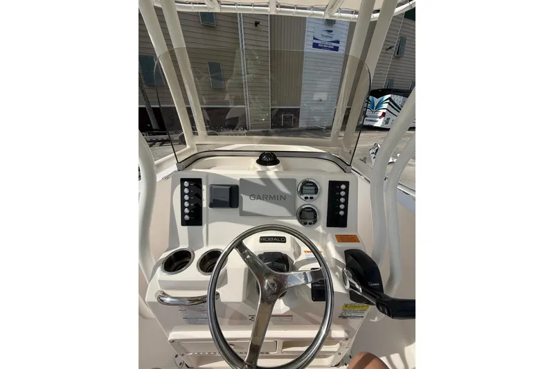Slide: The Image of 2021 Robalo R180 Center Console boat dashboard with Garmin navigation system. - 2