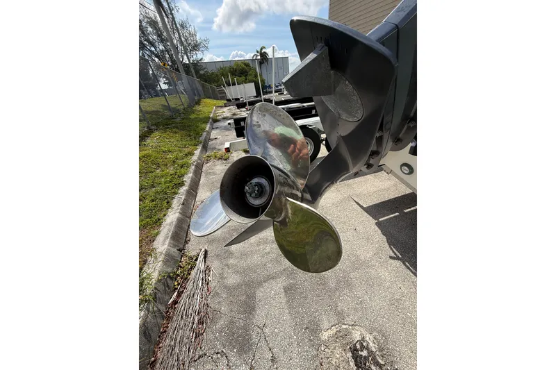 Slide: The Image of Propeller of 2021 Robalo R180 Center Console boat on pavement background. - 20