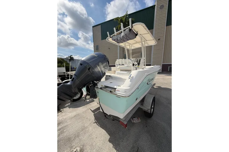Slide: The Image of 2021 Robalo R180 Center Console boat with Yamaha outboard motor, parked outdoors. - 23