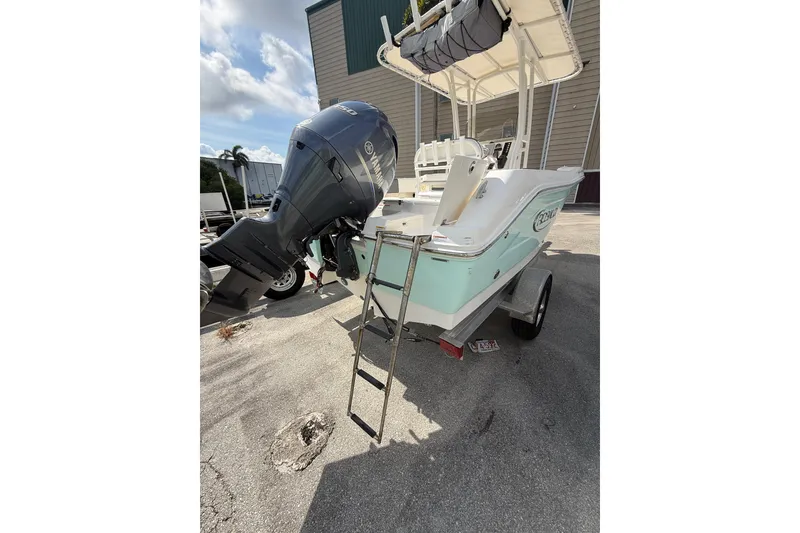Slide: The Image of 2021 Robalo R180 Center Console boat with Yamaha outboard motor on trailer. - 24