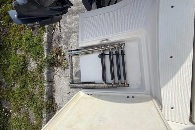 Slide: The Image of 2021 Robalo R180 Center Console boat with folded swim ladder and outboard motor. - 30
