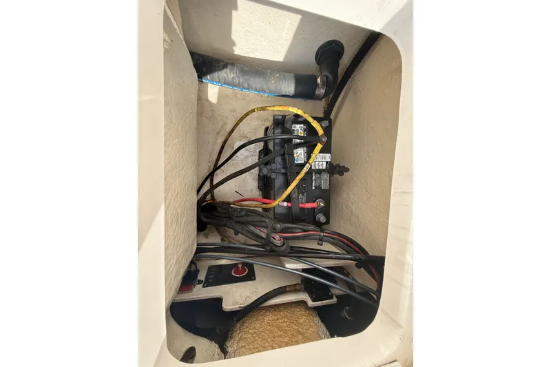 Slide: The Image of 2021 Robalo R180 Center Console boat battery compartment with wiring and connections. - 31