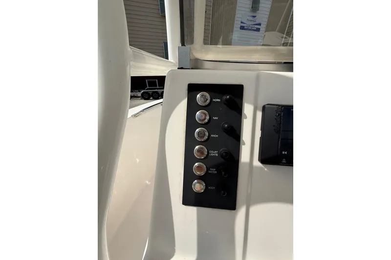 Slide: The Image of 2021 Robalo R180 Center Console boat dashboard with control switches. - 4