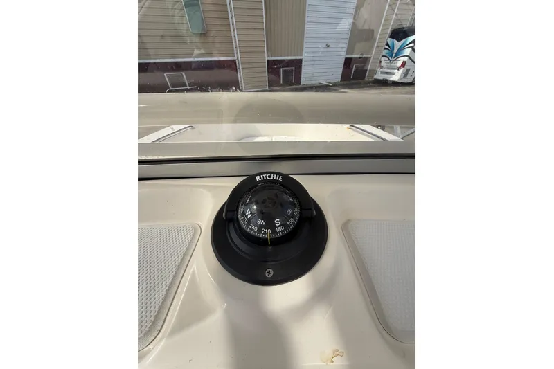 Slide: The Image of Compass on 2021 Robalo R180 Center Console boat dashboard, showing southwest direction. - 5