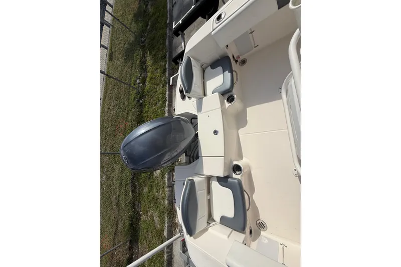 Slide: The Image of 2021 Robalo R180 Center Console boat interior with seating and engine view. - 7