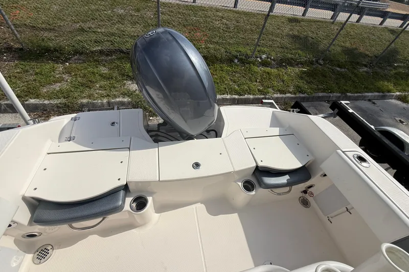Slide: The Image of 2021 Robalo R180 Center Console boat interior with seating and storage compartments. - 8