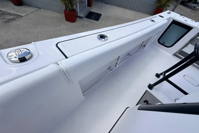 Slide: The Image of 2025 Sportsman Open 232 Center Console boat deck with storage compartments. - 11