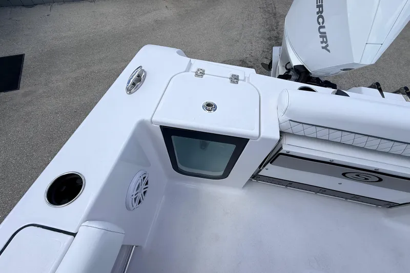 Slide: The Image of 2025 Sportsman Open 232 Center Console boat deck with storage and Mercury engine. - 13
