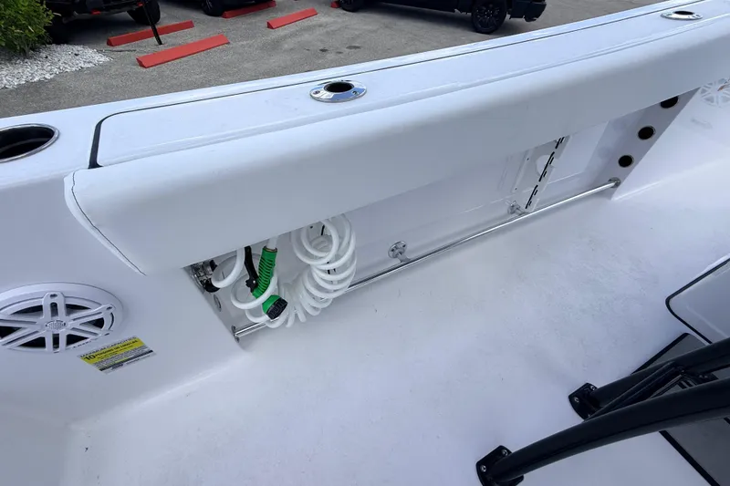 Slide: The Image of 2025 Sportsman Open 232 Center Console boat interior with storage compartment and speaker. - 15