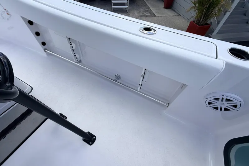 Slide: The Image of 2025 Sportsman Open 232 Center Console boat interior with rod holders and speaker. - 16