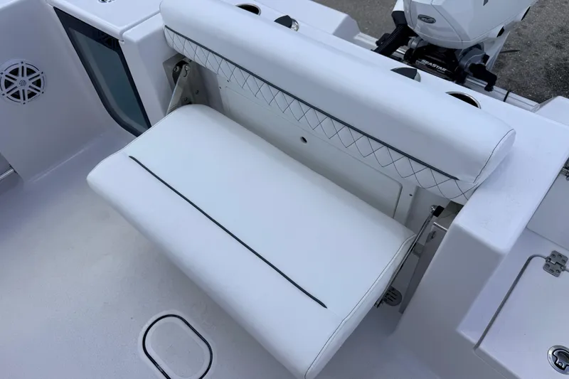 Slide: The Image of 2025 Sportsman Open 232 Center Console boat seat with white upholstery and diamond stitching. - 18
