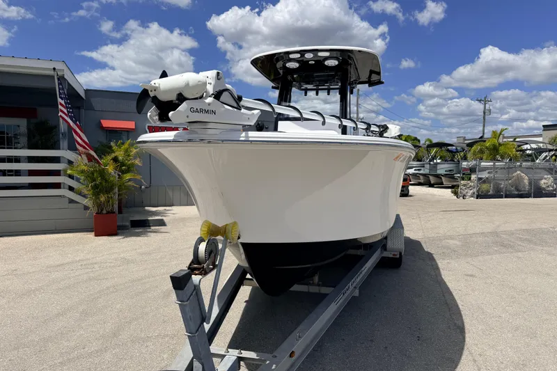 Slide: The Image of 2025 Sportsman Open 232 Center Console boat on trailer under blue sky. - 2