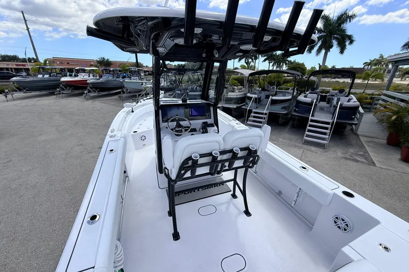 Slide: The Image of 2025 Sportsman Open 232 Center Console boat at a marina, surrounded by other boats. - 4