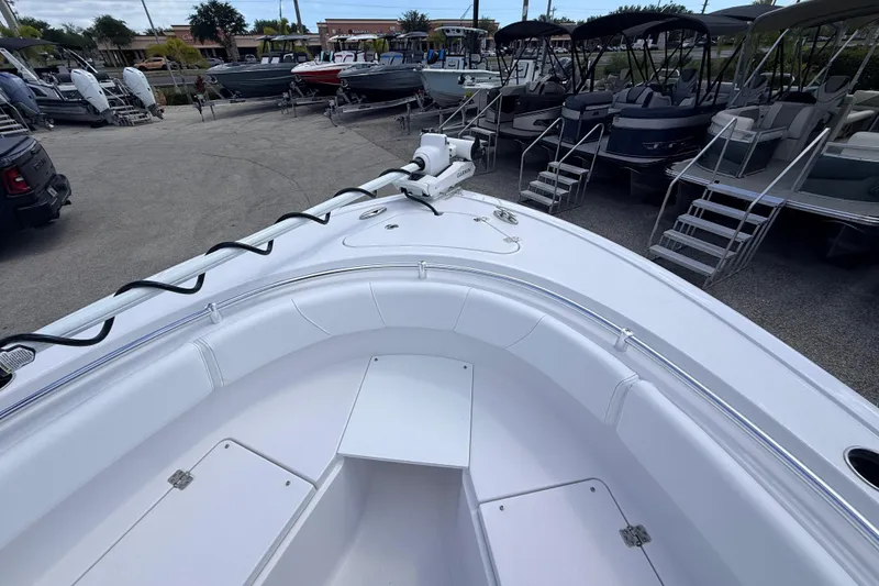 Slide: The Image of 2025 Sportsman Open 232 Center Console boat displayed in a marina with other vessels. - 7