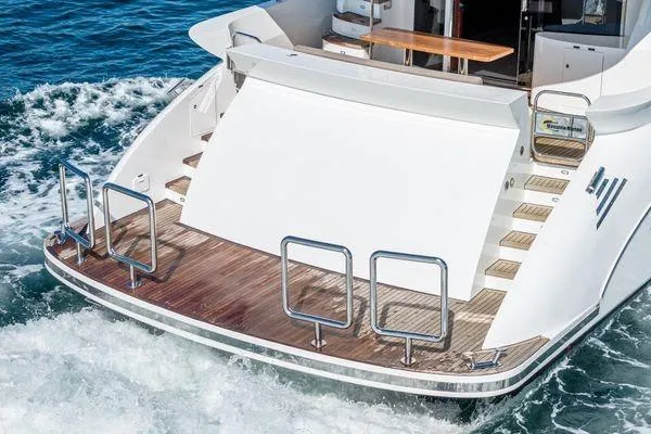 Slide: The Image of 2023 Massimo Marine Sunbird yacht stern with wooden deck and ocean waves. - 11