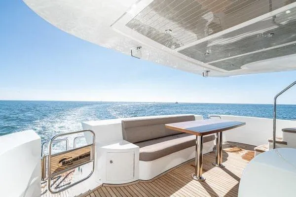 Slide: The Image of Luxurious 2023 Massimo Marine Sunbird yacht deck with ocean view and elegant seating area. - 13