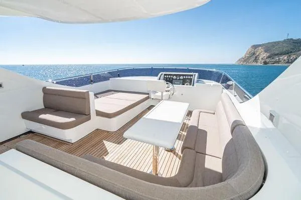 Slide: The Image of Luxurious 2023 Massimo Marine Sunbird yacht deck with seating, ocean view, and clear skies. - 17