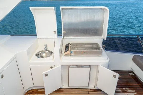 Slide: The Image of Outdoor kitchen on 2023 Massimo Marine Sunbird yacht with sink and grill by the sea. - 20