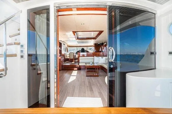 Slide: The Image of Luxurious 2023 Massimo Marine Sunbird yacht interior with elegant wood finishes and ocean view. - 22