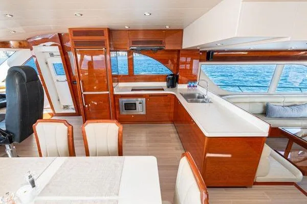 Slide: The Image of Luxurious 2023 Massimo Marine Sunbird yacht interior with modern kitchen and dining area. - 28