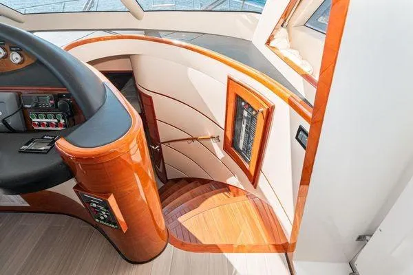 Slide: The Image of 2023 Massimo Marine Sunbird yacht interior with elegant wooden staircase and control panel. - 35