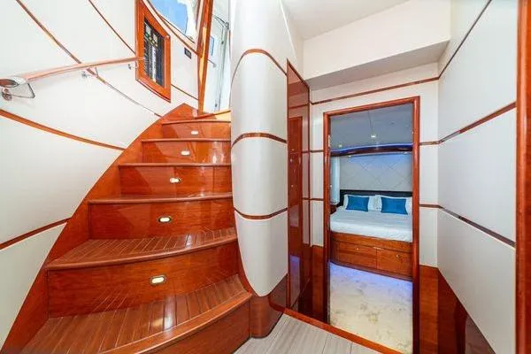 Slide: The Image of Luxurious interior of 2023 Massimo Marine Sunbird yacht with wooden staircase and cozy bedroom. - 36