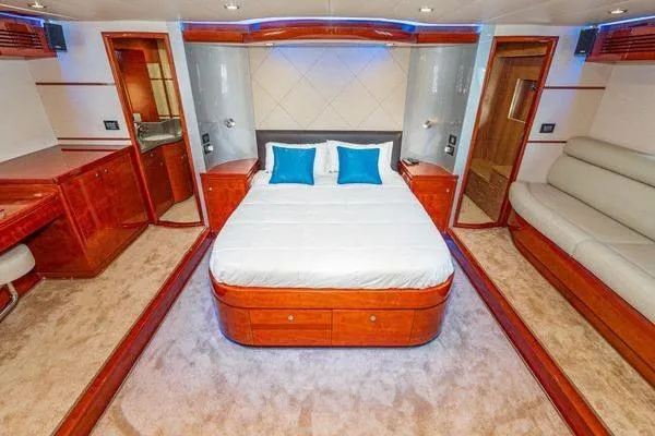 Slide: The Image of Luxurious 2023 Massimo Marine Sunbird yacht bedroom with elegant wood finishes and modern amenities. - 37