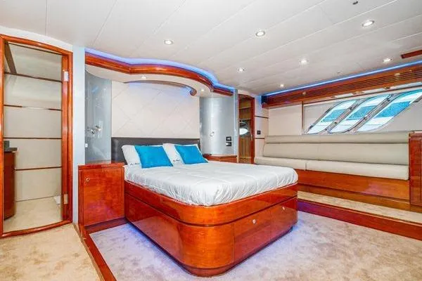 Slide: The Image of Luxurious 2023 Massimo Marine Sunbird yacht bedroom with modern design and elegant wood finishes. - 38