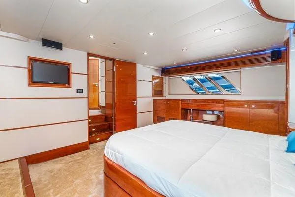 Slide: The Image of Luxurious 2023 Massimo Marine Sunbird yacht bedroom with modern wood finishes and elegant decor. - 39