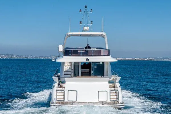 Slide: The Image of 2023 Massimo Marine Sunbird yacht cruising on open water, rear view. - 4