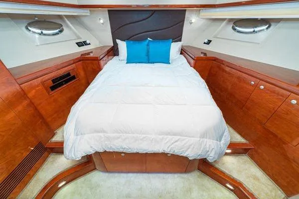 Slide: The Image of Luxurious 2023 Massimo Marine Sunbird yacht cabin with elegant wood finish and cozy bedding. - 44