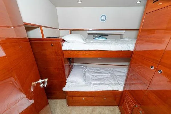 Slide: The Image of 2023 Massimo Marine Sunbird cabin with wooden bunk beds and storage. - 47