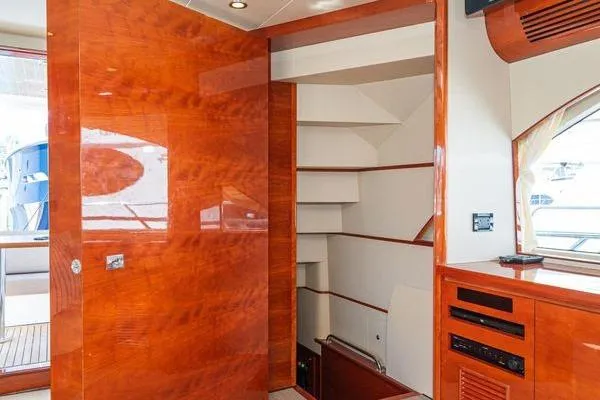 Slide: The Image of Interior of 2023 Massimo Marine Sunbird yacht with polished wood finish and staircase. - 48