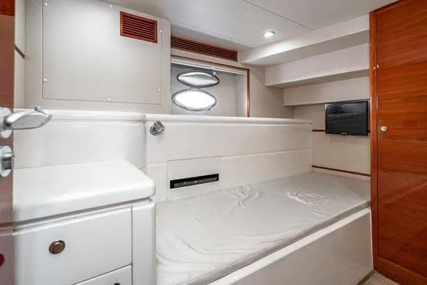Slide: The Image of Interior cabin of 2023 Massimo Marine Sunbird yacht, featuring a bed and porthole window. - 49