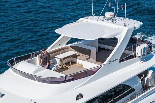 Slide: The Image of 2023 Massimo Marine Sunbird yacht cruising on open water, featuring spacious deck and modern design. - 6