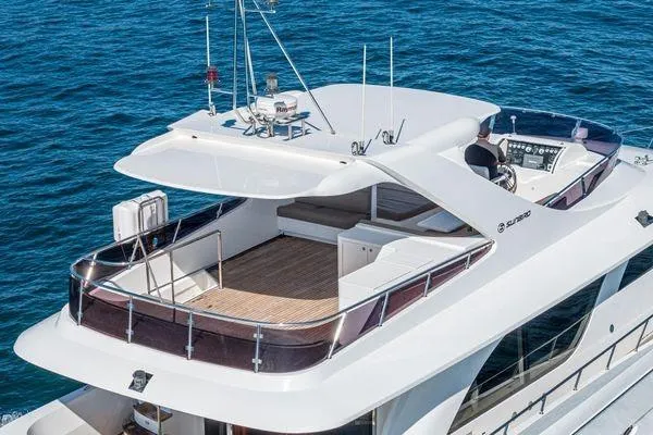 Slide: The Image of Luxurious 2023 Massimo Marine Sunbird yacht on open sea, featuring spacious deck and modern design. - 7