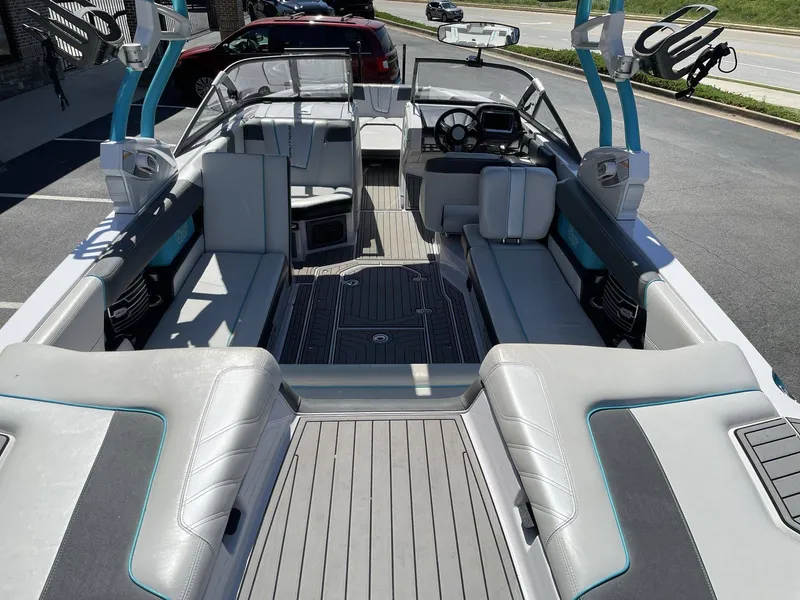 Slide: The Image of Interior of a 2015 Nautique G25 boat, gray upholstery, modern design. - 12
