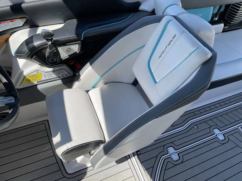 Slide: The Image of Interior of a 2015 Nautique G25 boat with luxurious seating. - 15