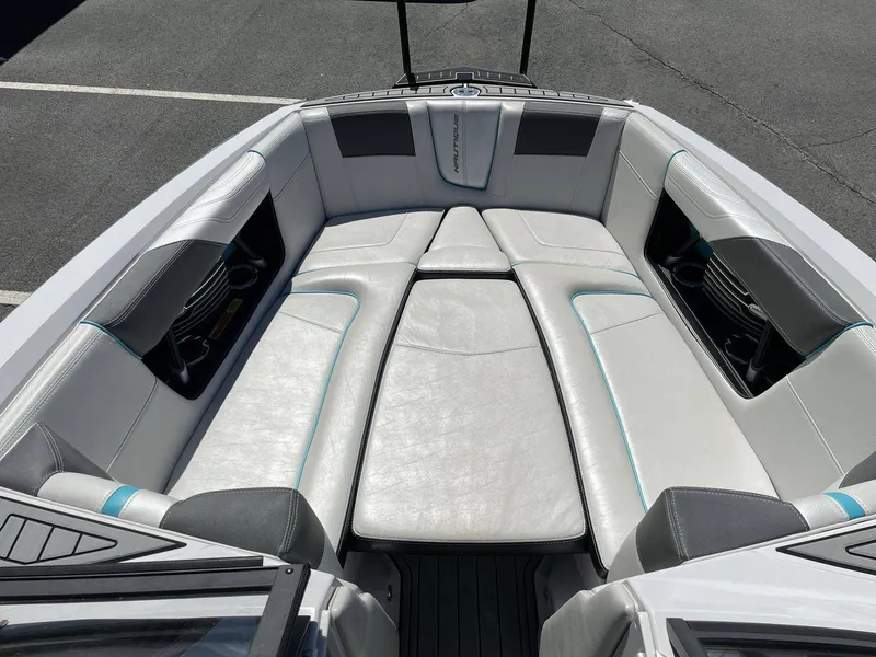 Slide: The Image of Interior of a 2015 Nautique G25 boat with white upholstery. - 22